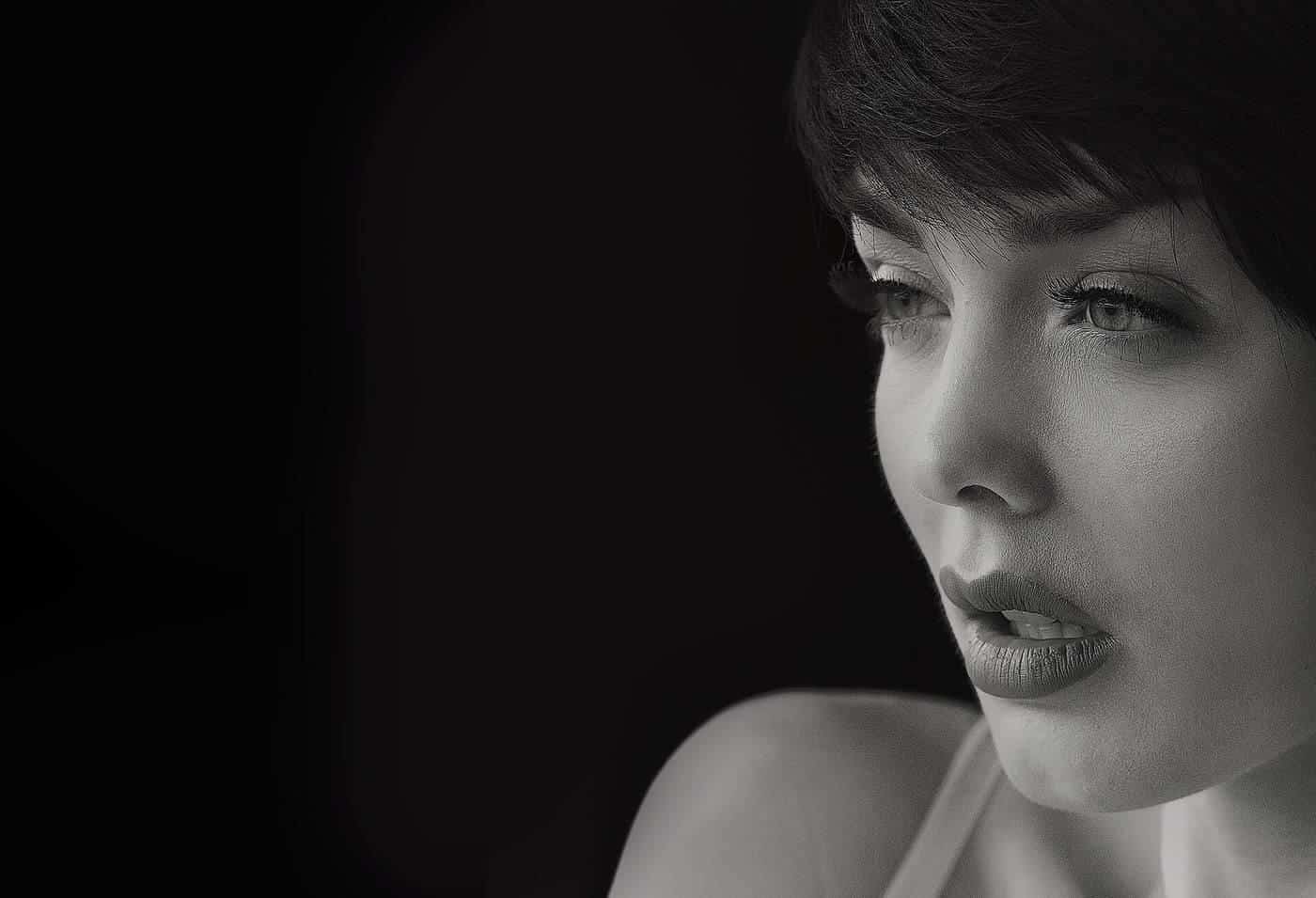 A black-and-white portrait of a young woman