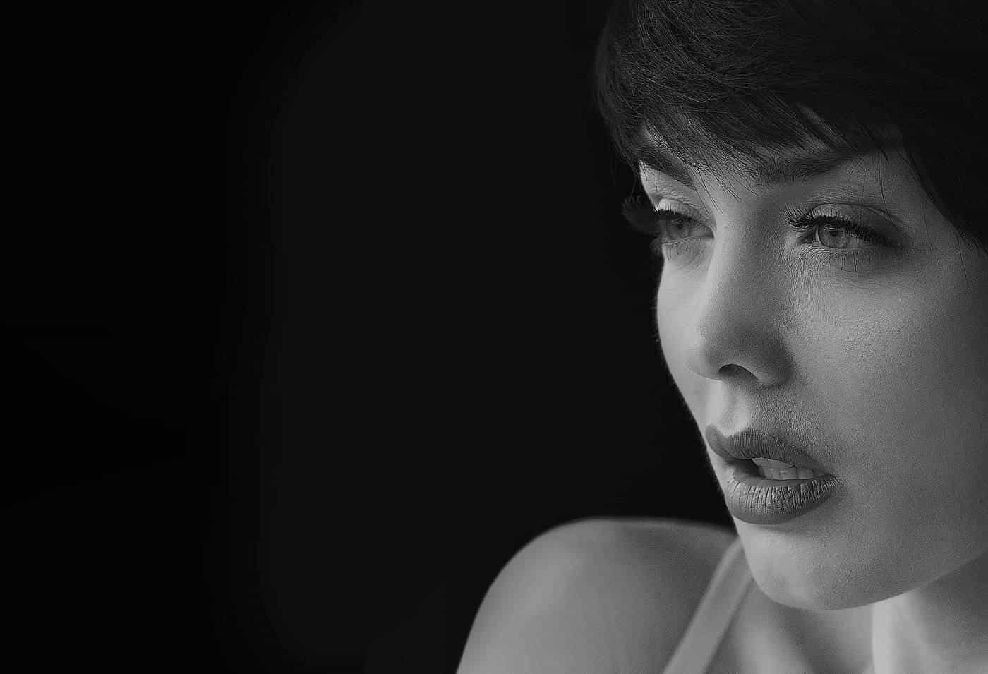 A black-and-white portrait of a young woman